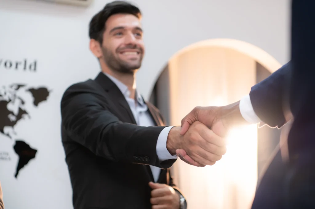 Un homme qui sert la main d'un autre avec le sourrire