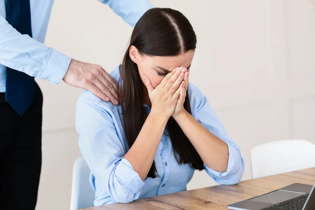 Une femme qui pleure au bureau à cause d'une sanction d'absence injustifiée au travail